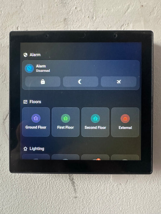 An NS Panel Pro with a Home Assistant Dashboard. It shoes An Alarm panel and the floors of a house